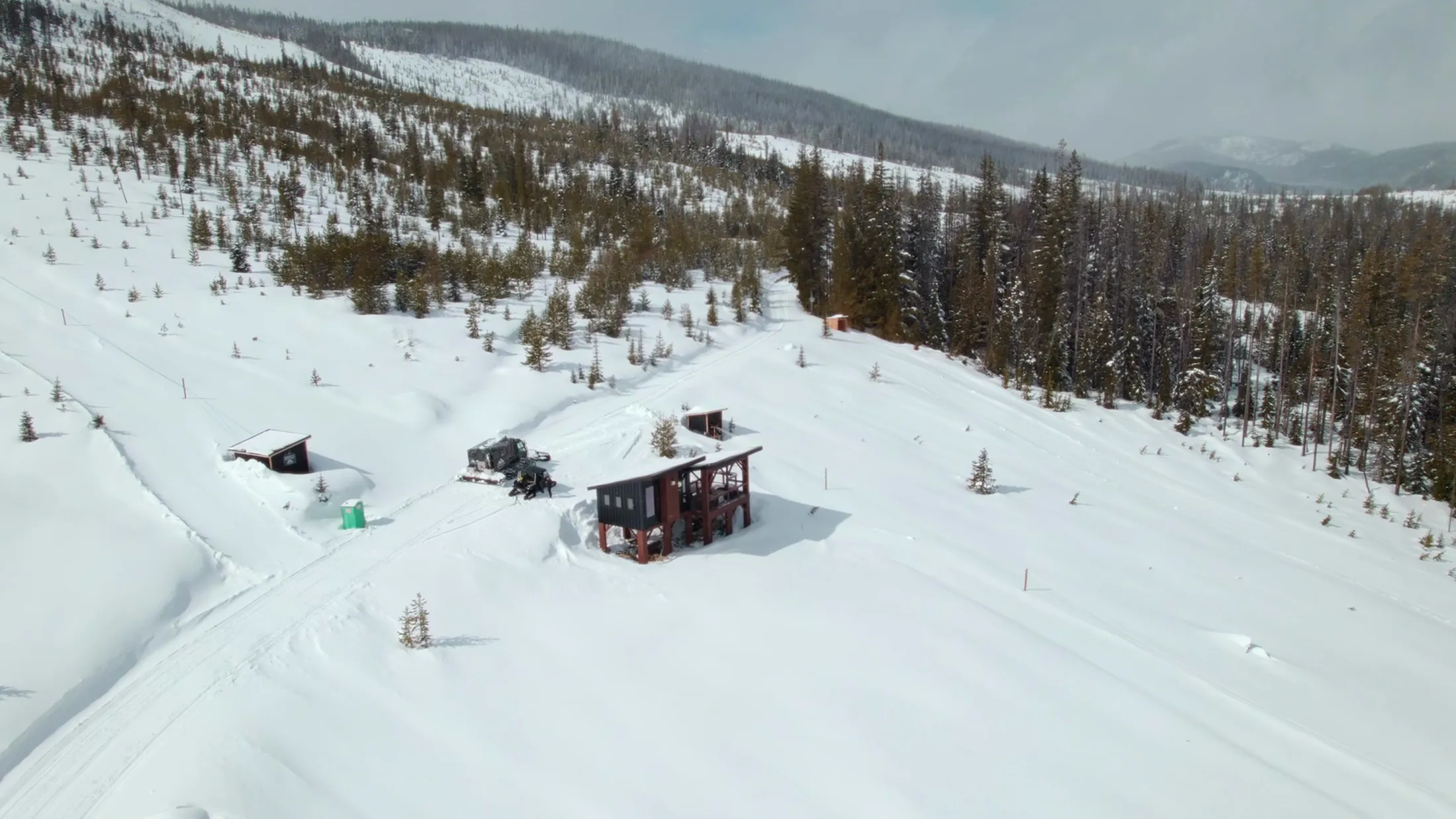Aerial of cabins in a snowy clearing