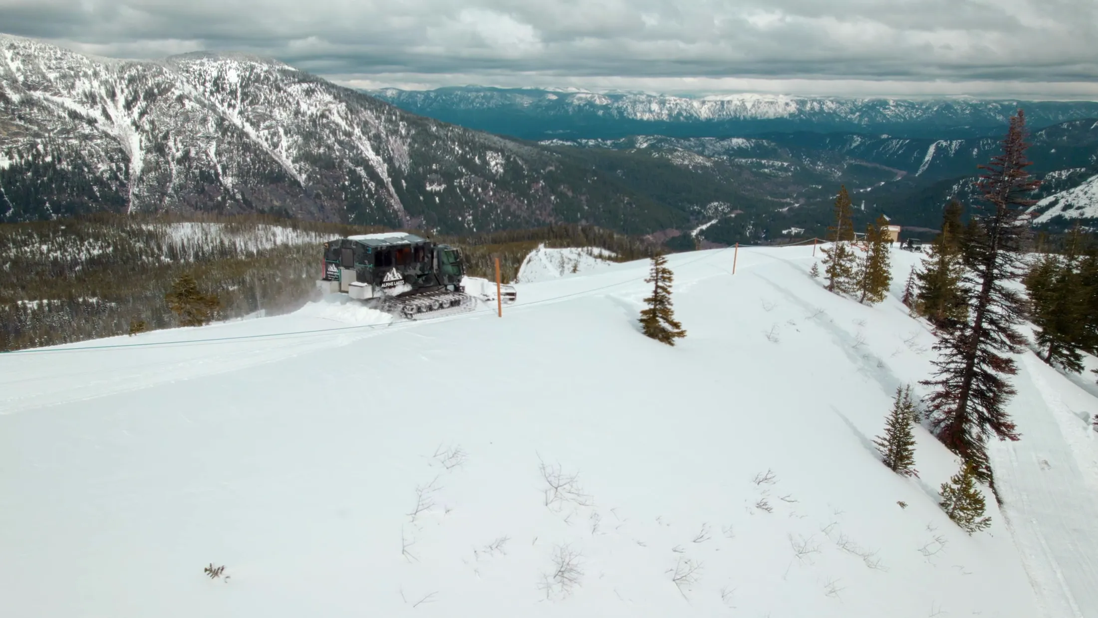 Aerial of a cabin on a snowy ridge