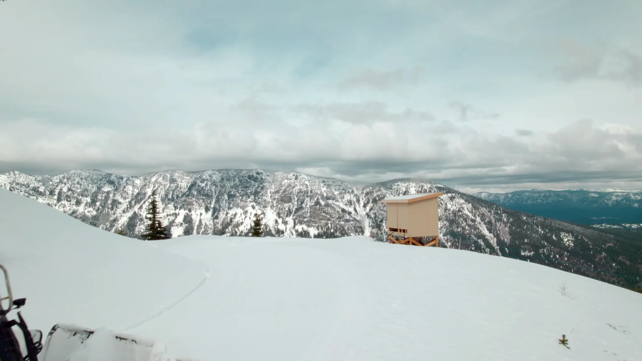 Aerial of the Summit Hut on a snowy ridge