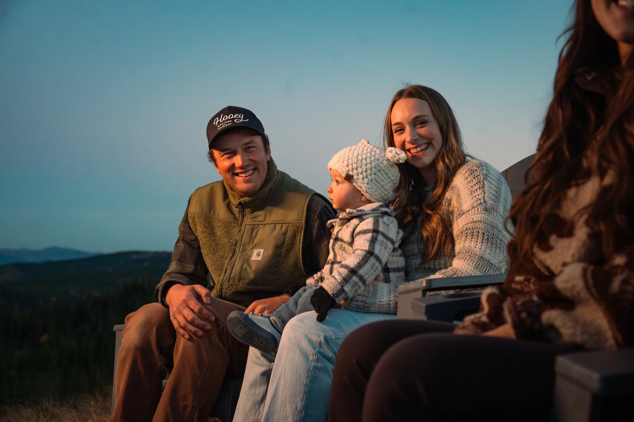 Family laughing together at golden hour