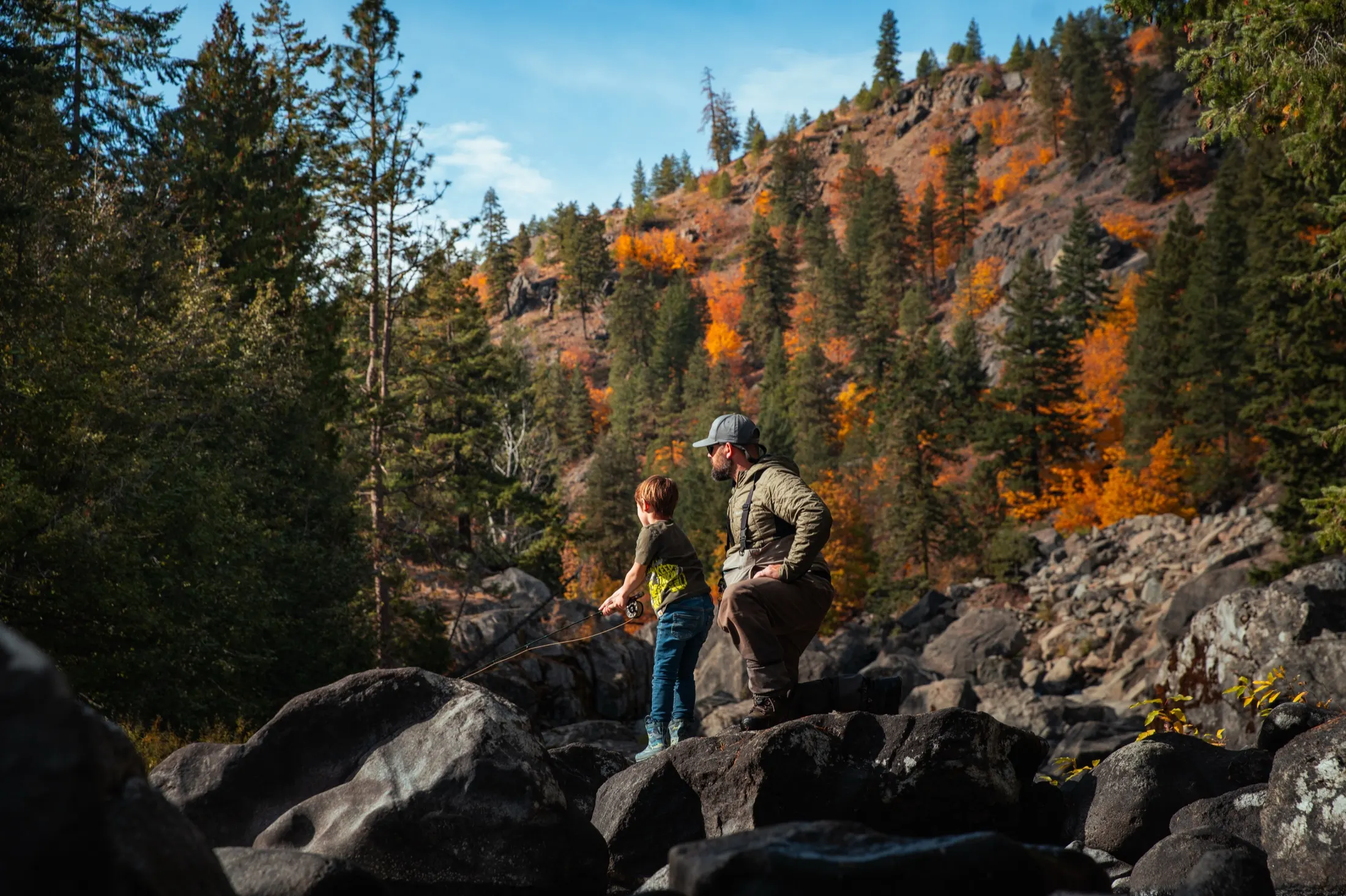 Angler on the rocks of a river canyon