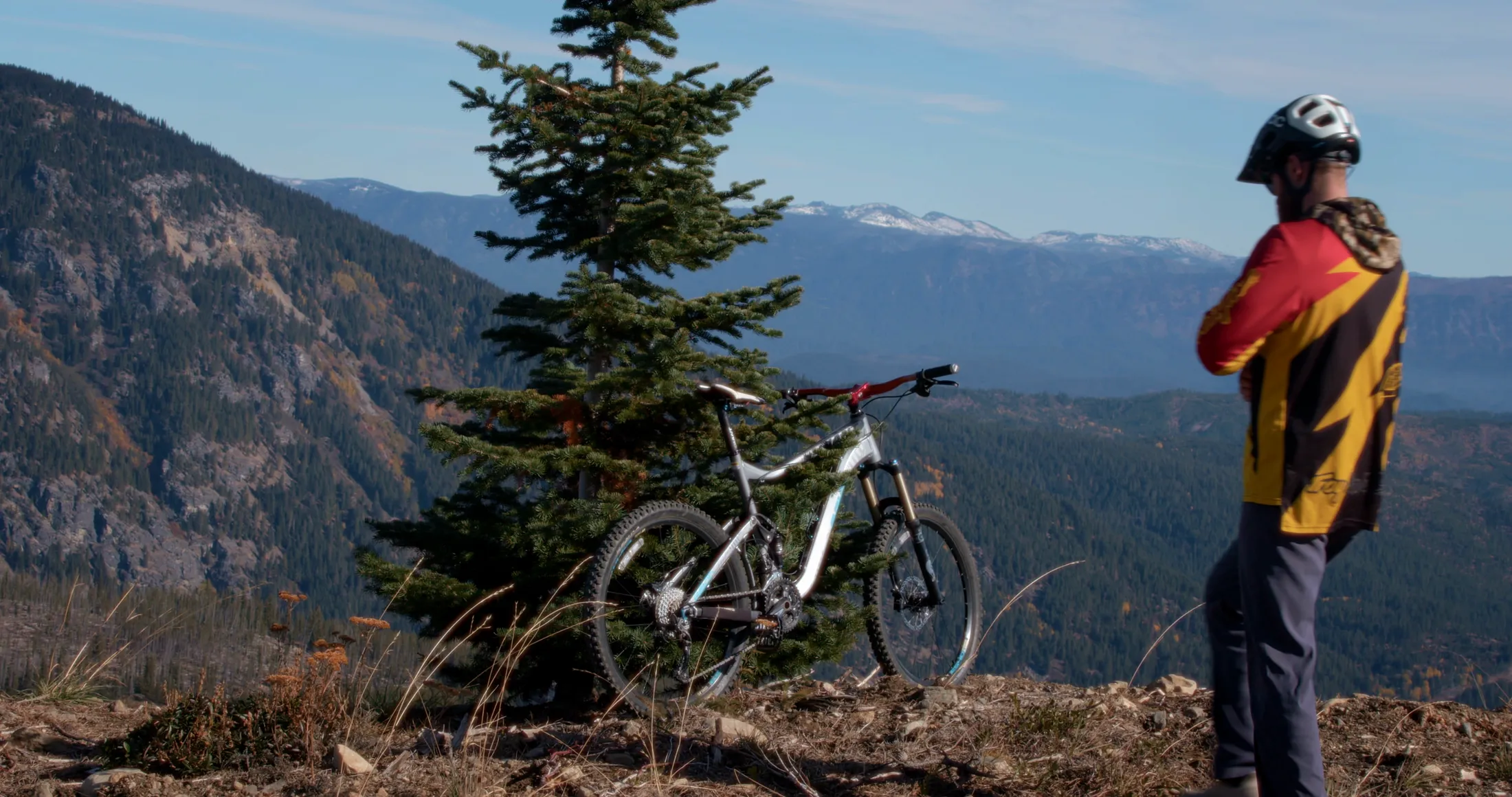 Mountain biker resting at an overlook above the valley