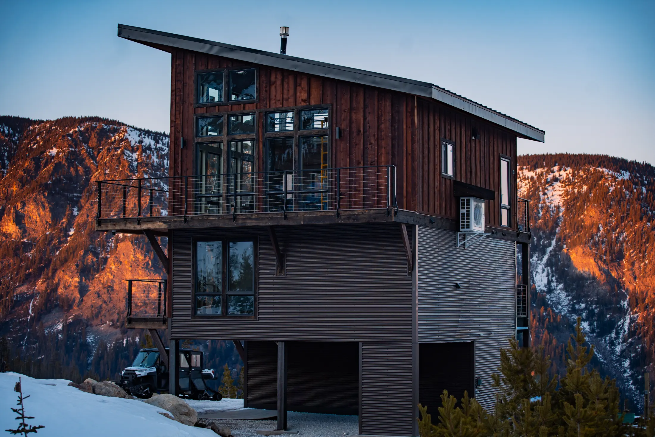 Watchtower cabin at dusk with alpenglow on the ridge behind it