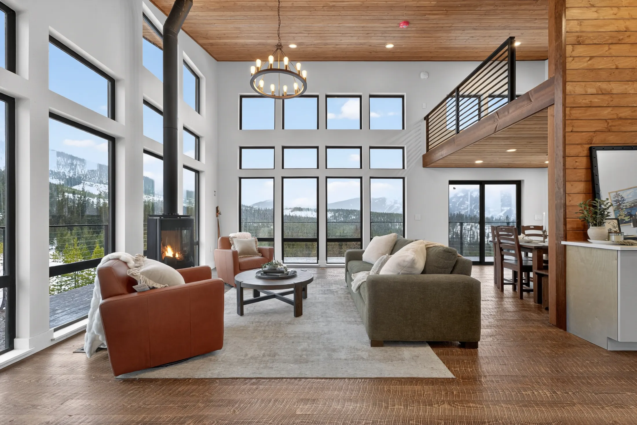 Watchtower living room with tall windows onto snowy peaks