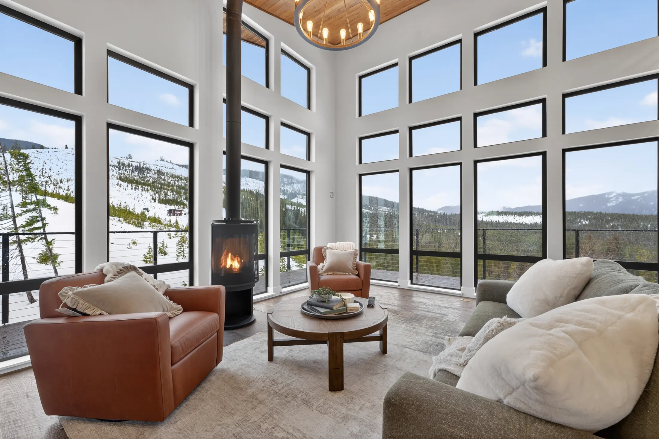 Living area with a wood stove and mountain views