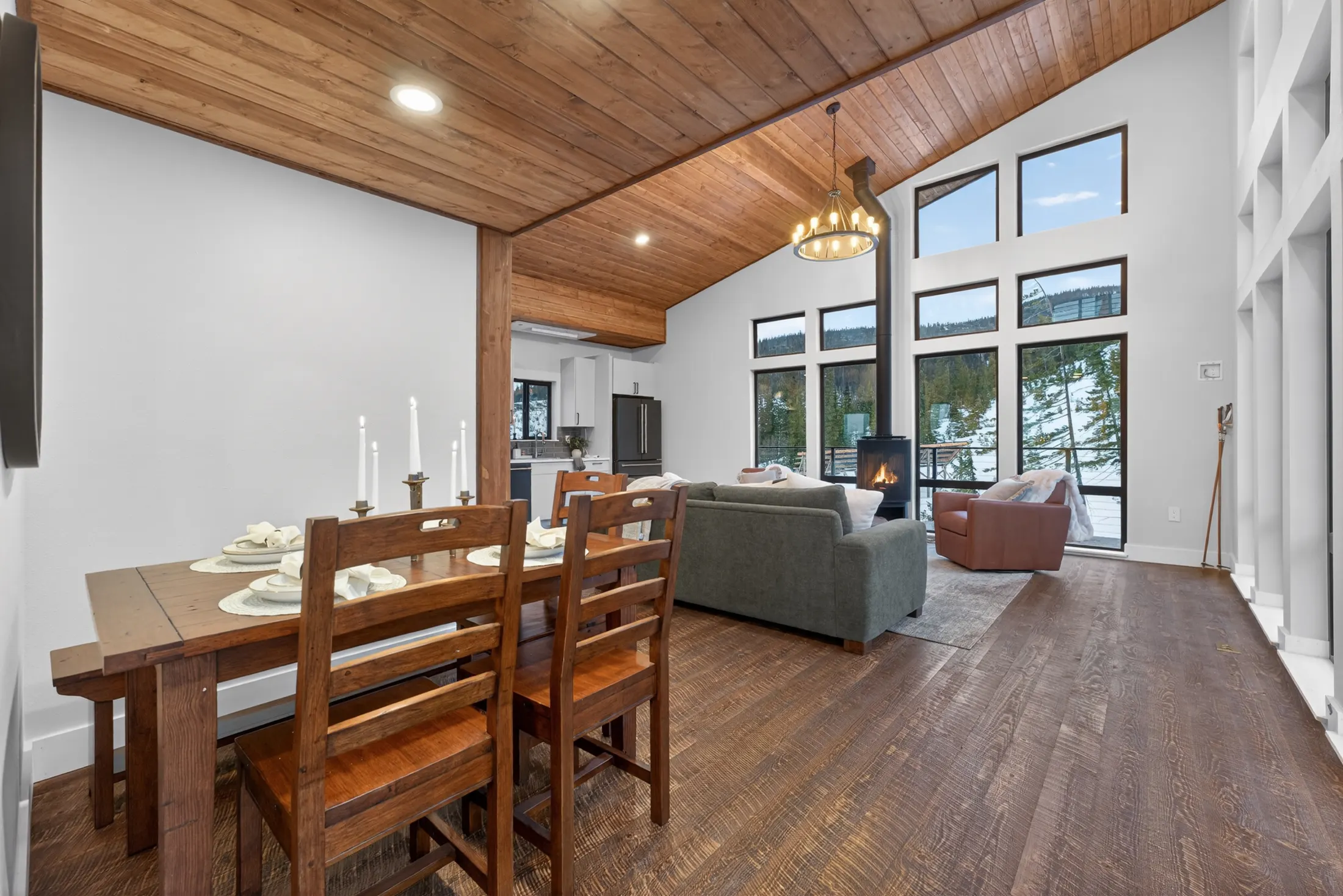 Dining table beside a wall of windows