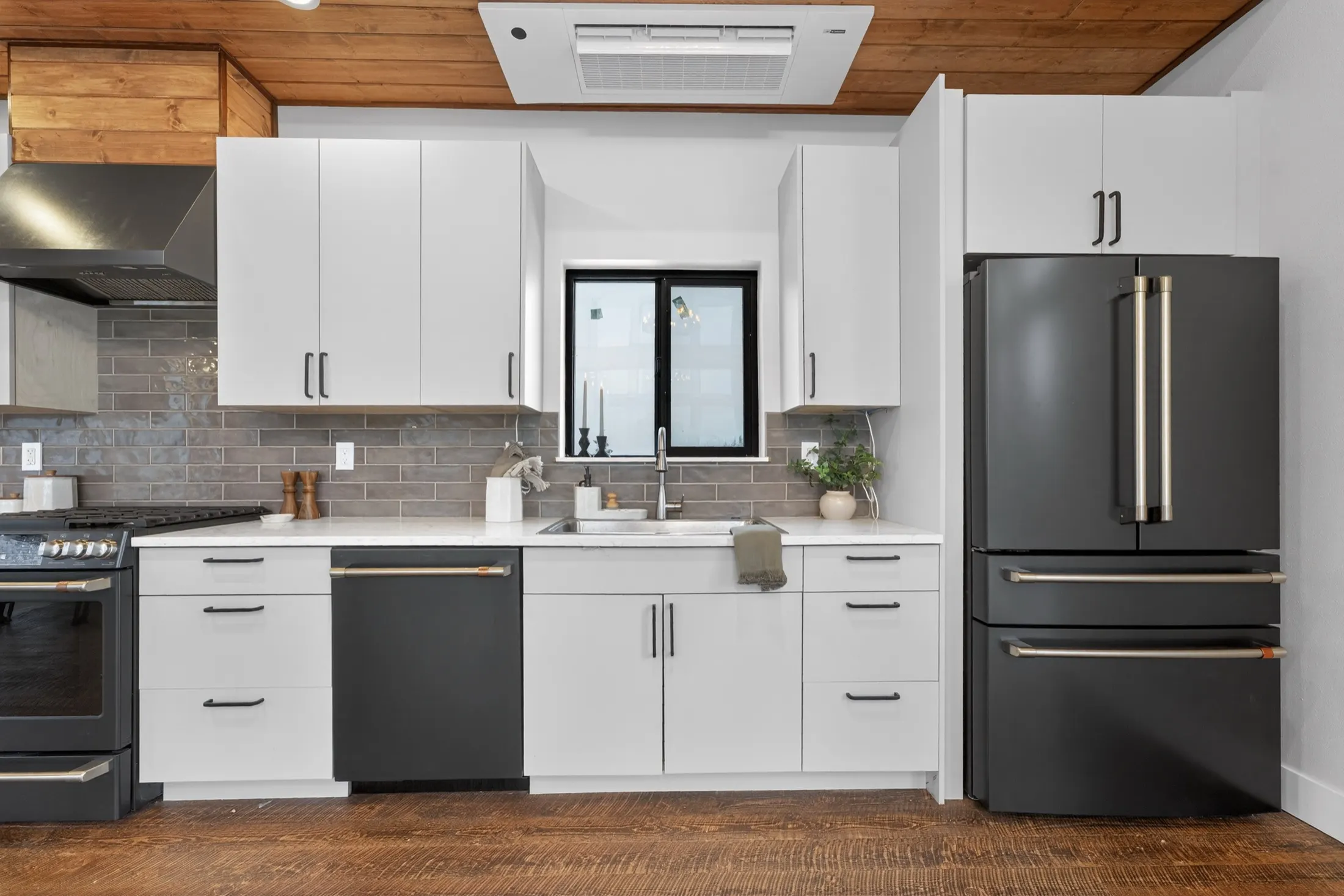 Kitchen with a black range and stainless fridge
