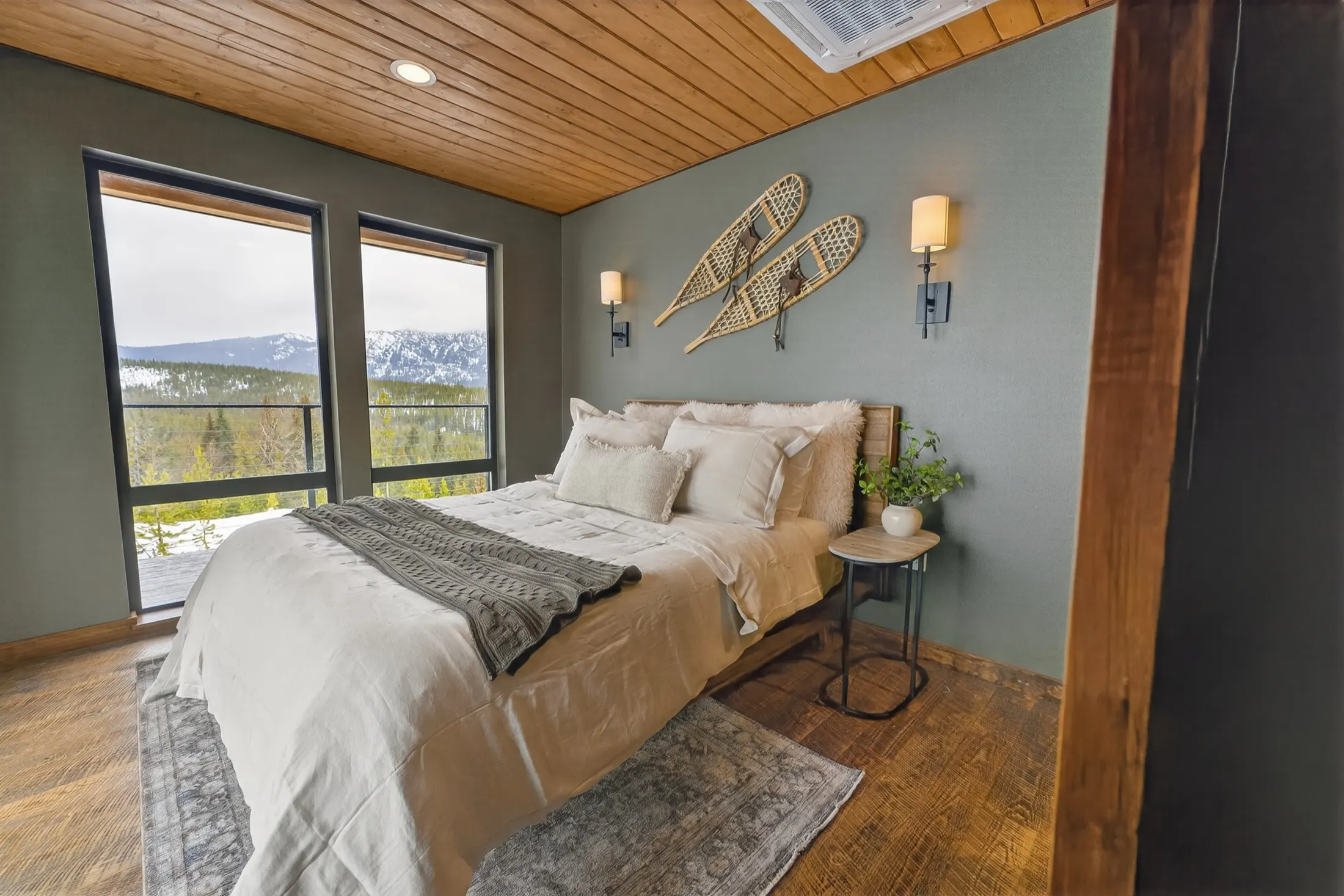Bedroom with snowshoes on the wall and mountain views