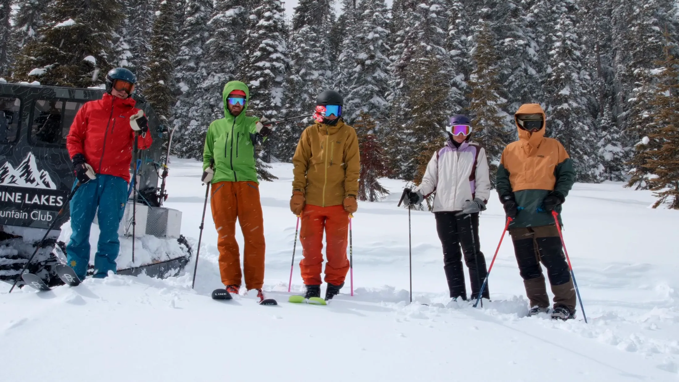 Skiers gathered beside the club snowcat